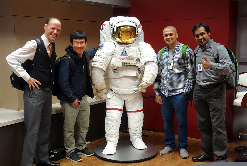 People standing with Astronaut suit